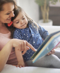 Mom reading book to daughter