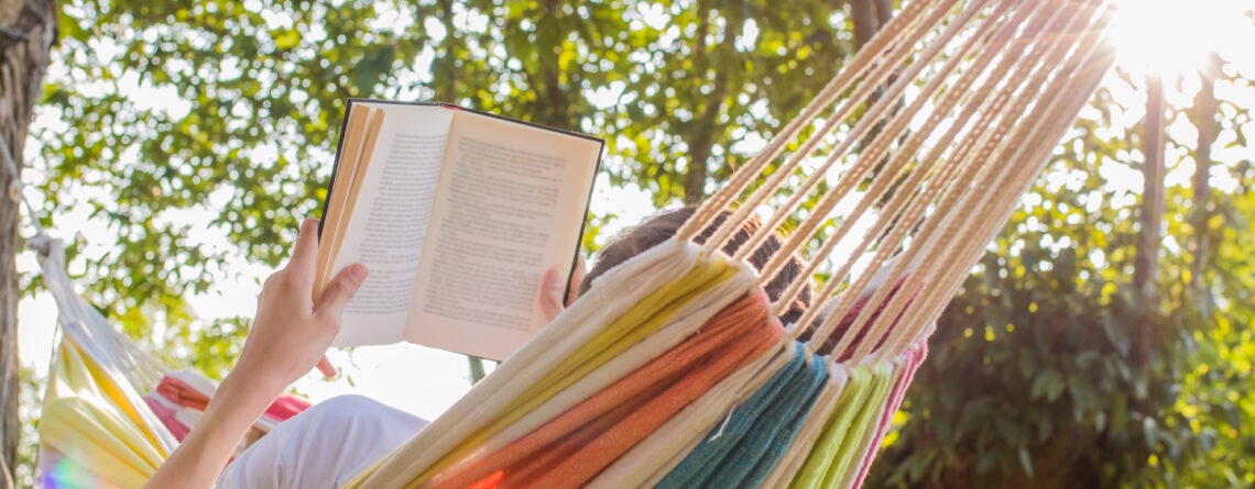 reading for mental health at dusk in the hammock with the open book