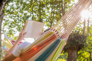 reading for mental health at dusk in the hammock with the open book