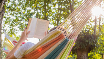 reading for mental health at dusk in the hammock with the open book