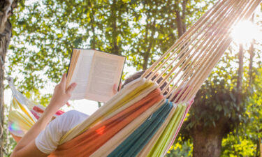 reading for mental health at dusk in the hammock with the open book