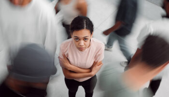 Woman experiences social anxiety in a crowd.